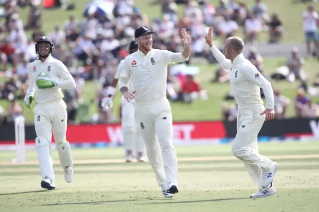 Ben Stokes (C) and Jack Leach (R) of England celebrate the wicket of Jeet Raval of New Zealand during day two of the first Test match between New Zealand and England