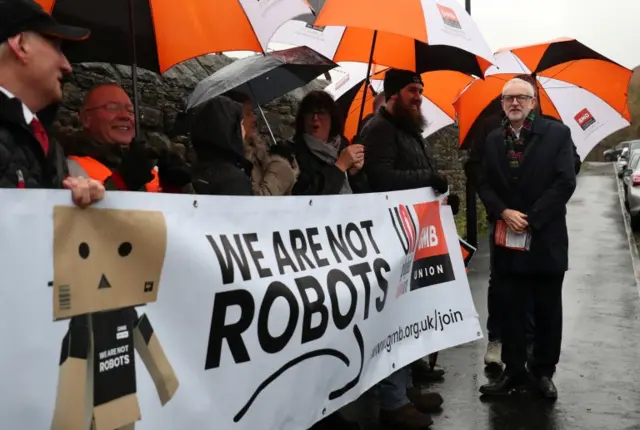 Labour Party leader Jeremy Corbyn stands outside Amazon's depot in Sheffield