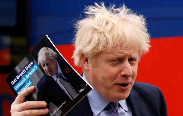 Boris Johnson with manifesto book