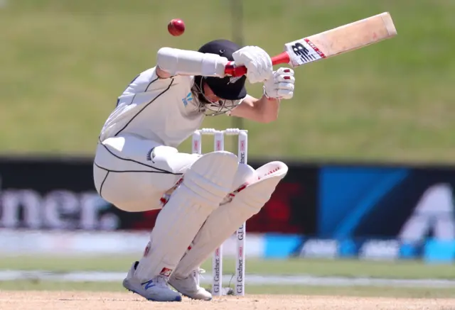 Mitchell Santner avoids a short delivery from England"s Jofra Archer during the fourth day of the first cricket Test between England and New Zealand at Bay Oval in Mount Maunganui,