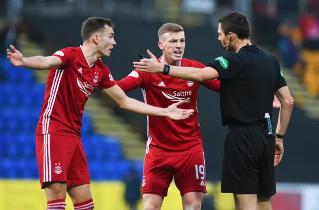 Aberdeen players protest to referee Kevin Clancy