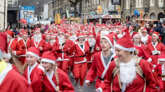 Photos of Santas running