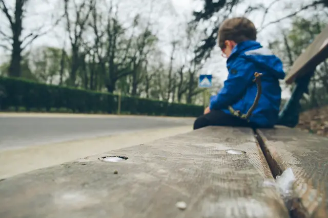 Child sitting on bench