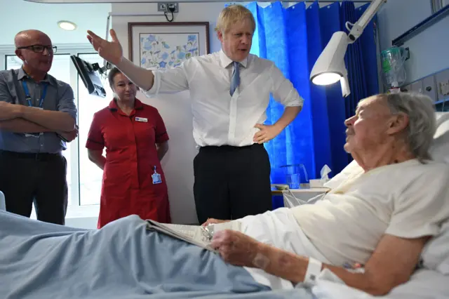 Prime Minister Boris Johnson speaks with Patient Andrew Hall as he visits West Cornwall Community Hospital, in Penzance, Cornwall