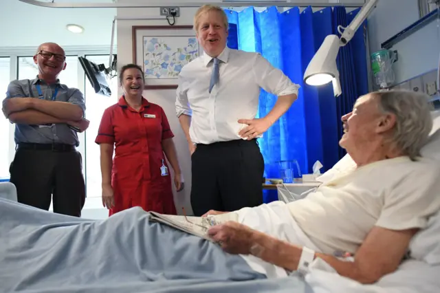 Prime Minister Boris Johnson speaks with patient Andrew Hall as he visits West Cornwall Community Hospital, in Penzance, Cornwall, whilst on the General Election campaign trail.