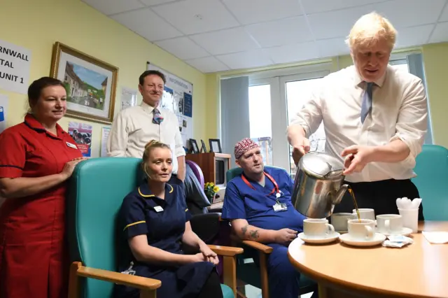 Prime Minister Boris Johnson serves tea with staff members as he visits West Cornwall Community Hospital, in Penzance, Cornwall, whilst on the General Election campaign trail.