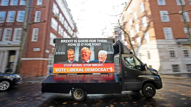 One of four poster vans that are set to tour Liberal Democrat/Conservative marginal seats at their unveiling in Smith Square, Westminster.