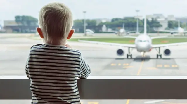 Boy watching a plane