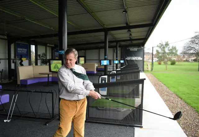 Brexit Party leader Nigel Farage hits a ball on a driving range during a general election campaign event venue in Hull, northeast England on November 28, 2019.