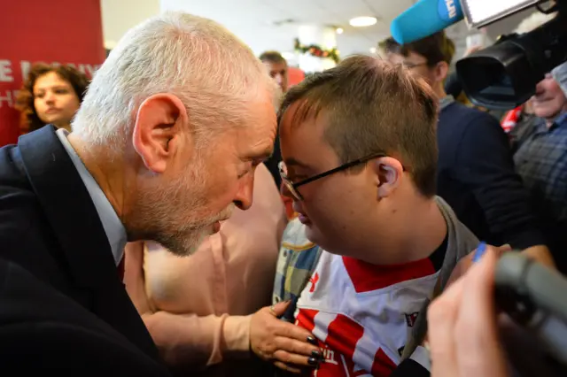 Opposition Labour party leader Jeremy Corbyn (L) meets supporter Jo Lambert after giving a speech on Labour"s environment policies while on the campaign trail in Southampton, southwest England