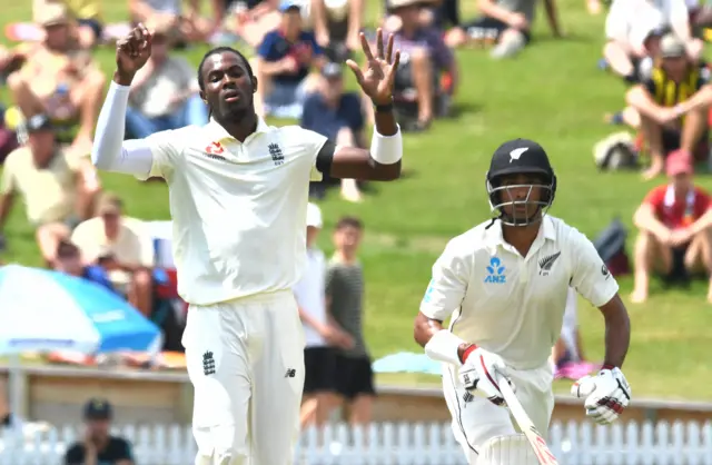 England's Jofra Archer reacts while New Zealand's Jeet Raval runs