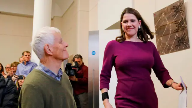 Liberal Democrat leader Jo Swinson (R) arrives to gives a speech on the campaign trail for the 2019 general election in London