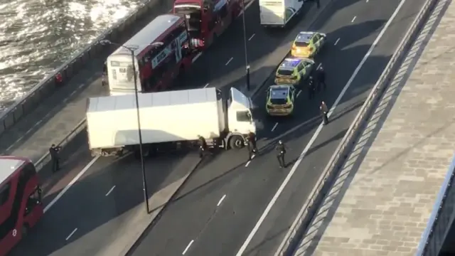 A white lorry across two lanes on the bridge