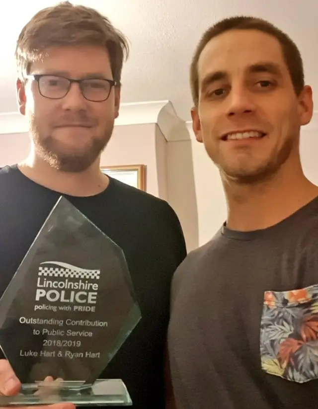 The brothers with their award