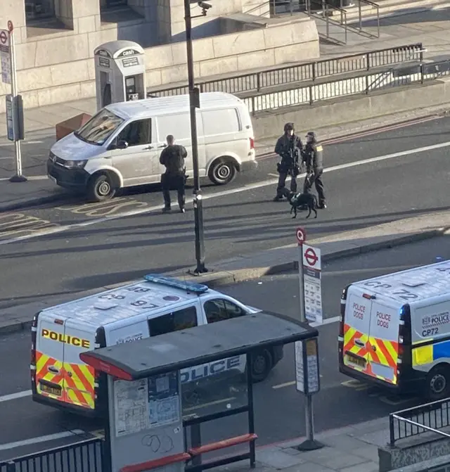 Officers near a white van on the bridge