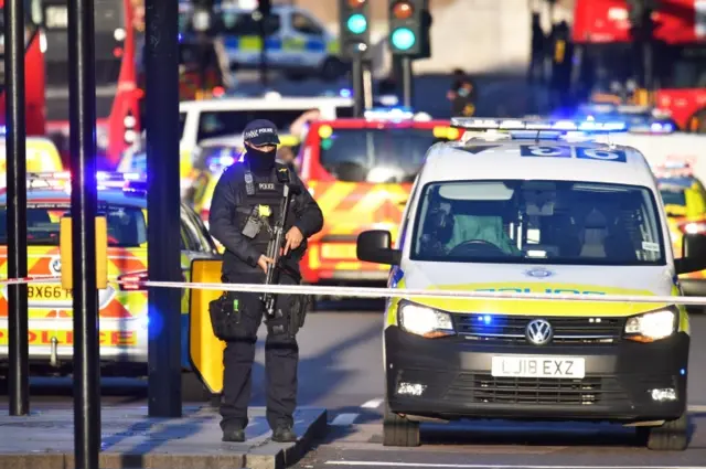 An armed officer stands guard