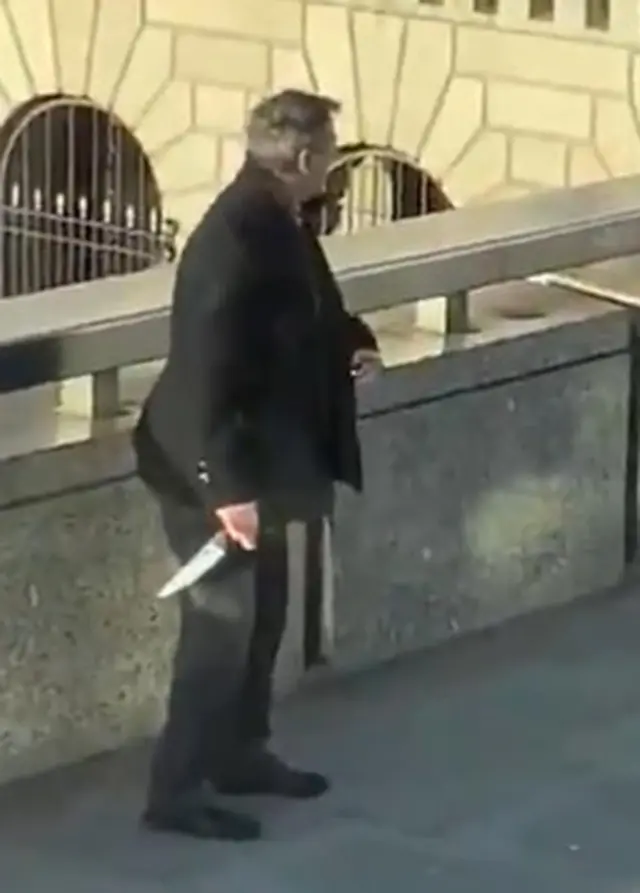 Another man in a suit and jacket could be seen running on the bridge, having apparently retrieved a large knife.