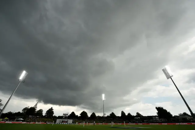 Storm clouds gather as play continues on the first day of the second cricket Test between England and New Zealand at Seddon Park in Hamilton