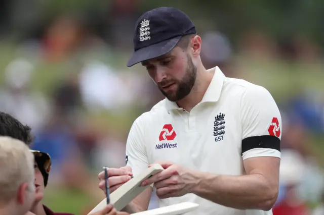 England's Chris Woakes signs autographs during day 1 of the second Test match between New Zealand and England at Seddon Park