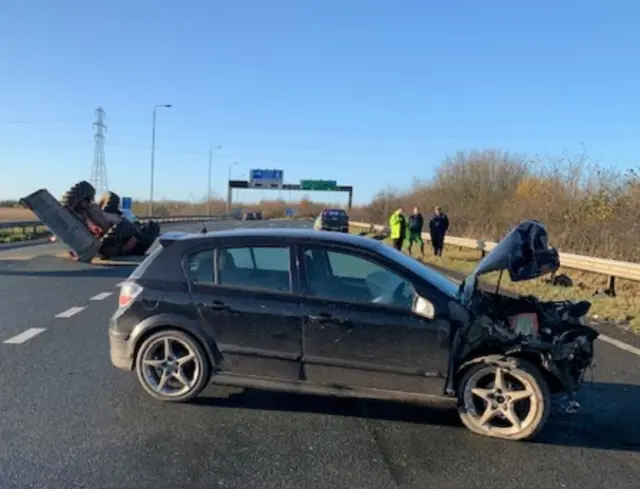 Overturned tractor and damaged car