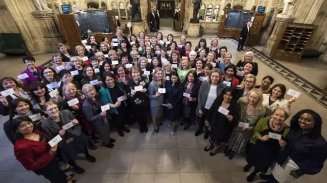 Women MPs standing in Parliament