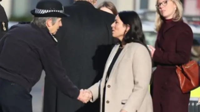 Home Secretary Priti Patel shaking hands with Cressida Dick