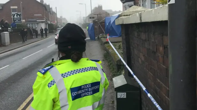 A police officer guards a cordon round a property in Stafford