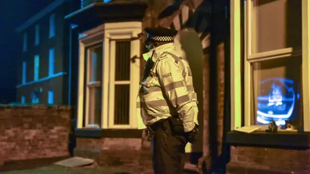 A police officer stands guard