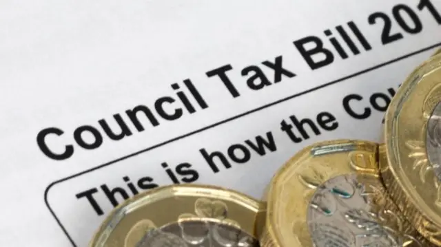 A council tax bill with money