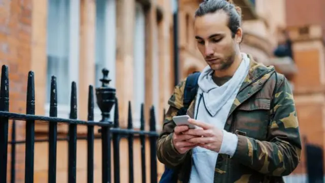 A man checks his phone.