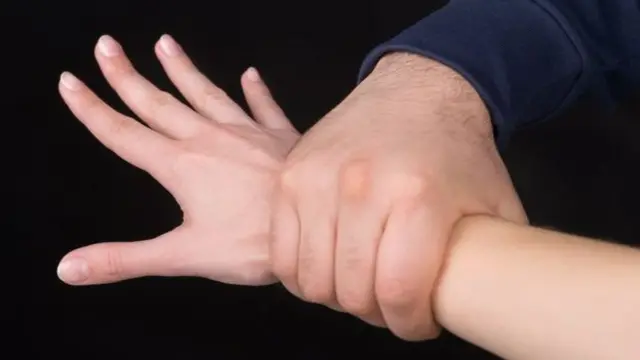 Child's wrist being held