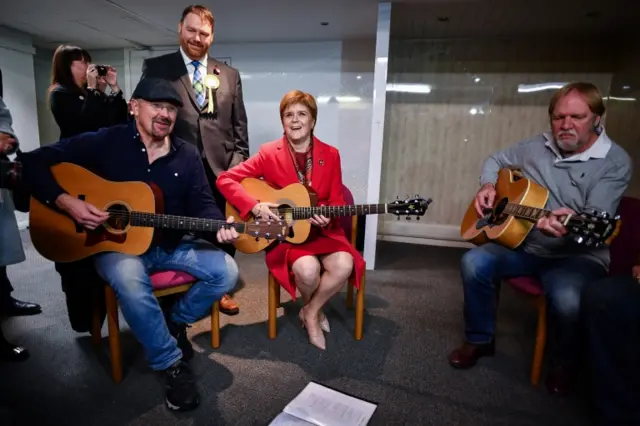 Nicola Sturgeon playing the guitar