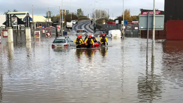 Firefighters in flood water