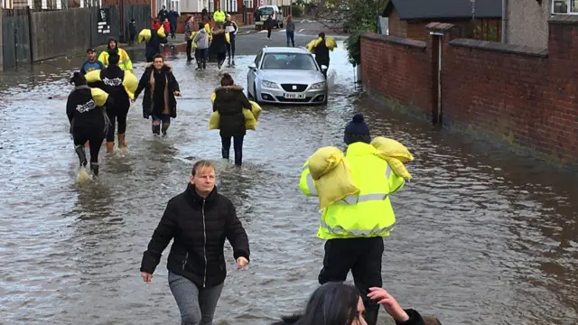 Residents move sandbags