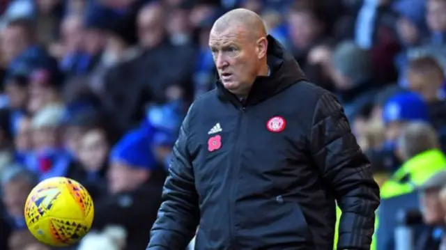 Hamilton manager Brian Rice controls the ball on the touchline