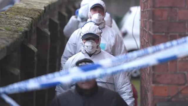 Police officers searching suspect's home