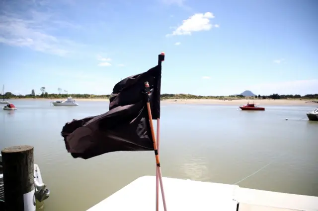 Black flags on boats