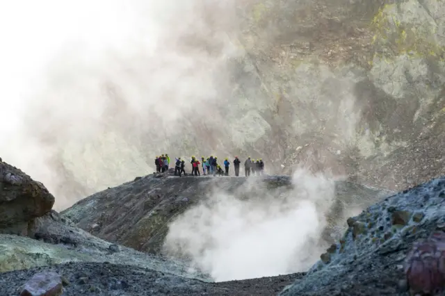 Tourists explore White Island on July 9, 2019 in Whakatane