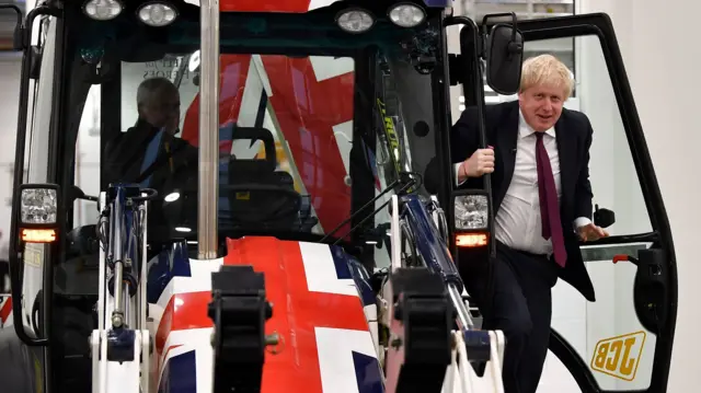 Boris Johnson getting out of the JCB