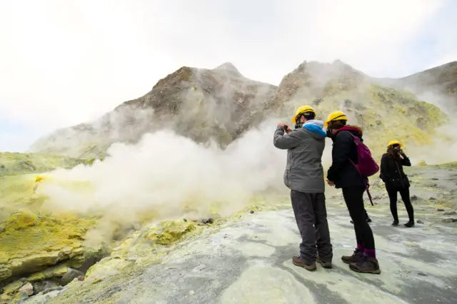 Tourists explore White Island on July 9, 2019 in Whakatane,