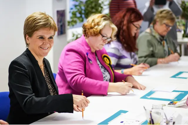 Nicola Sturgeon and SNP candidate Dr Philippa Whitford (2nd L) take part in a painting class with WASPI women at Little Art School on December 10, 2019 in Paisley, Scotland.