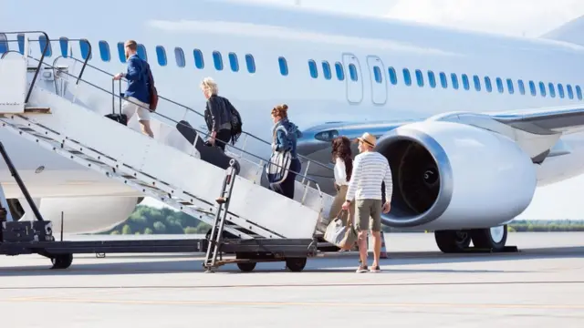 Passengers getting on a plane