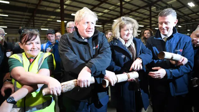 Boris Johnson holds a Christmas cracker