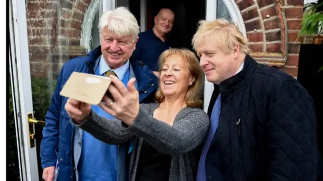 Stanley Johnson, a member of the public, and Boris Johnson take a selfie