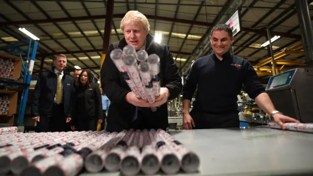 Boris Johnson helps package up wrapping paper