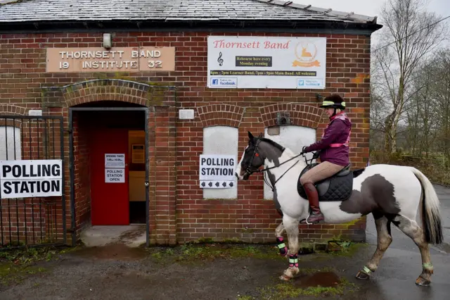 A woman on a horse leaves a polling station at Thornsett Band Institute in Thornsett, High Peak.