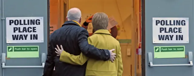 Nicola Sturgeon arrives at the polling station in Glasgow with her husband  Peter Murrell
