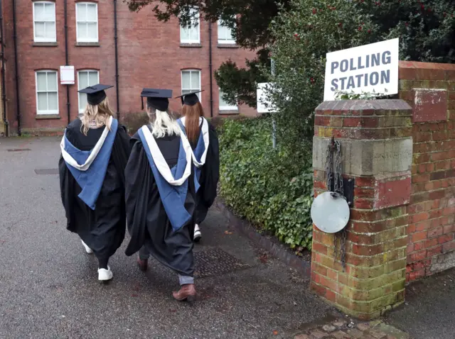 Students from the University of Reading arrive to vote in the General Election 2019 on graduation day.