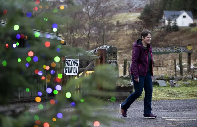 A woman leaves a polling station after voting at Gersask Primary School, Laggan in the Cairngorms.