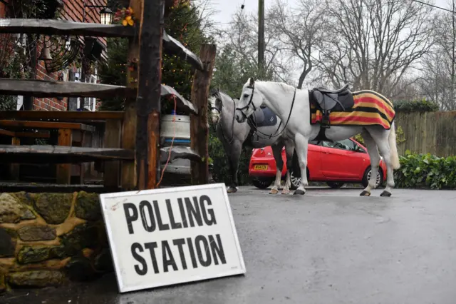 Horses are tethered outside The Rock Inn, being used as a polling station in Chiddinstone Hoath, near Edenbridge, south-east England.